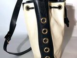 a black and white purse with a black strap