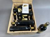 bottles of wine are in a wooden box on a table