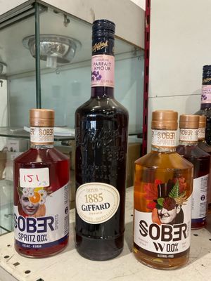 several bottles of alcohol are lined up on a counter
