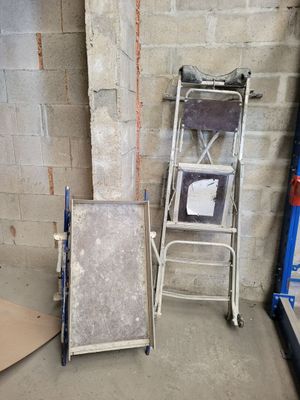 a ladder and a chair in a room with a brick wall