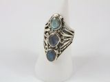 a close up of a silver ring with blue stones on it