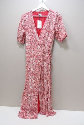 a red and white floral dress hanging on a hanger
