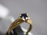 a gold ring with a blue stone on top of it