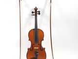 an old violin sitting on top of a white surface