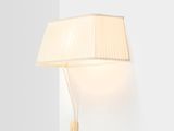 a white lamp on a white wall next to a white wall