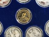 several coins are in a blue display case on a blue surface