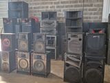 a lot of speakers sitting on the floor in a room