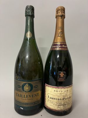 two bottles of champagne sitting next to each other on a table