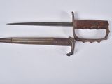 pair of old and rusty knifes on a white surface