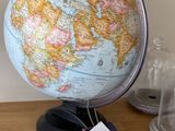 un petit globe terrestre posé sur une table, avec une étiquette de prix dessus