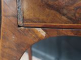 a close up of a wooden table with a mirror on it