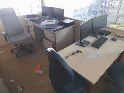 a desk with two computer monitors and a keyboard on it