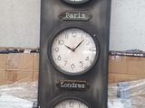 three clocks that are on the wall next to a box