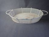 an old white metal basket with handles and handles on a black background