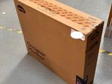 a cardboard box sitting on the floor in the middle of the floor
