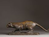 bronze sculpture of a panther on a rock on a gray background