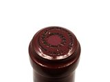 a close up of a bottle of wine on a white surface