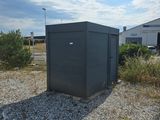 une petite boîte noire posée au milieu d'un champ de gravier