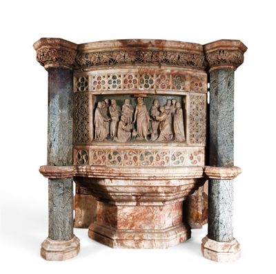 a statue of a group of people sitting on top of a pedestal