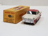 a toy car that is sitting next to a box