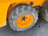 a yellow tractor that is parked on the side of the road
