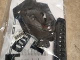 a plastic bag with a watch inside of it on the floor