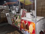 a food cart that has a lot of food on it