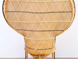 an image of a wicker chair sitting on top of a gray floor