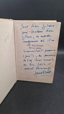 an open book with a handwritten note on it sitting on a table
