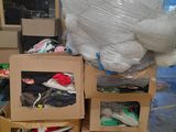 a large stuffed animal sitting on top of a pile of boxes