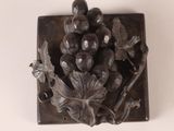 a metal object with a bunch of grapes on it