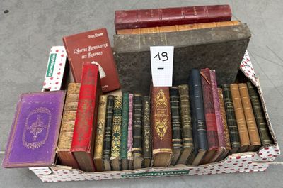 many old books in a box on the floor