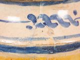 a blue and white vase sitting on a table