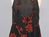 a black and red dress with red flowers on it