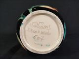 a close up of a vase with writing on it