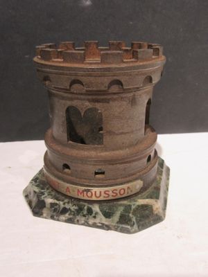 a small wooden tower with a sign on it