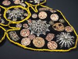a close up of a piece of cloth with coins on it