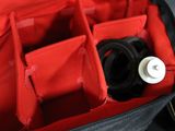 a black and red bag with a bottle inside of it