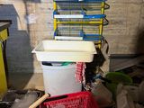 a pile of trash in a room next to a trash can
