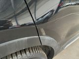 a close up of a car ' s front tire with a hole in the tire