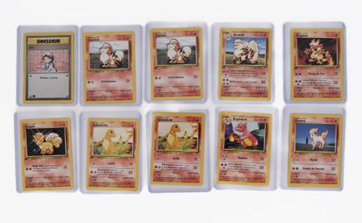 a close up of a collection of pokemon cards on a white surface