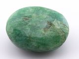 an image of a green stone on a white surface