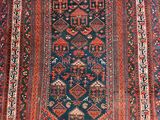 an antique persian rug with a blue and red design
