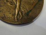 a gold coin with a picture of a woman on it