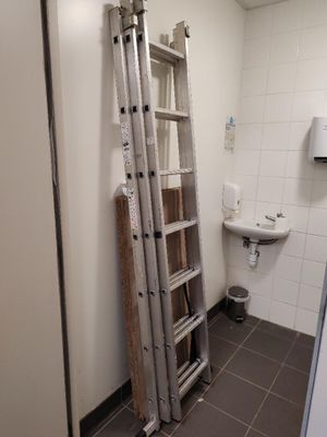 a ladder leaning up against a wall in a bathroom