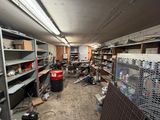 a room filled with lots of clutter and lots of shelves