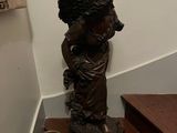 a statue of a woman on the stairs of a house