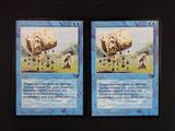 two cards that are on a black table