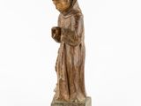 an image of a statue of a monk holding a book