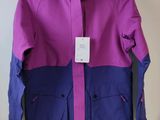 a close up of a purple and blue jacket hanging on a wall